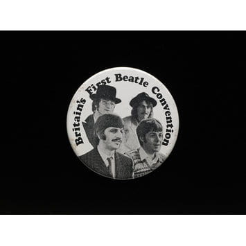 Black and white image of a pin badge with the four musicians all looking right. Words curve along the top edge say 'Britain's First Beatle Convention'